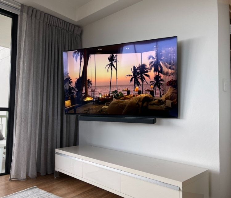 A living room with a flat screen tv hanging on the wall