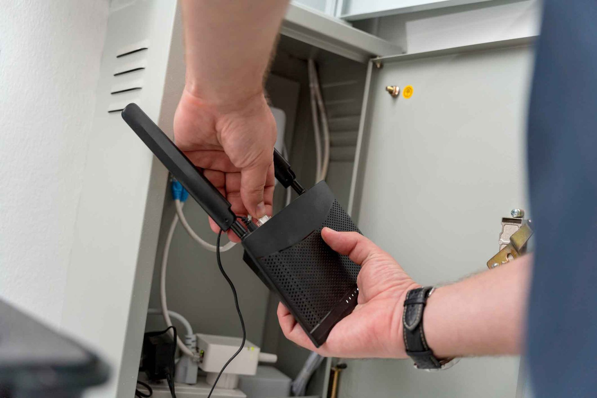 A person is holding a remote control in their hand.