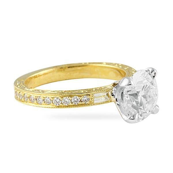 Yellow gold engagement ring with a round brilliant diamond and vintage milgrain detailing