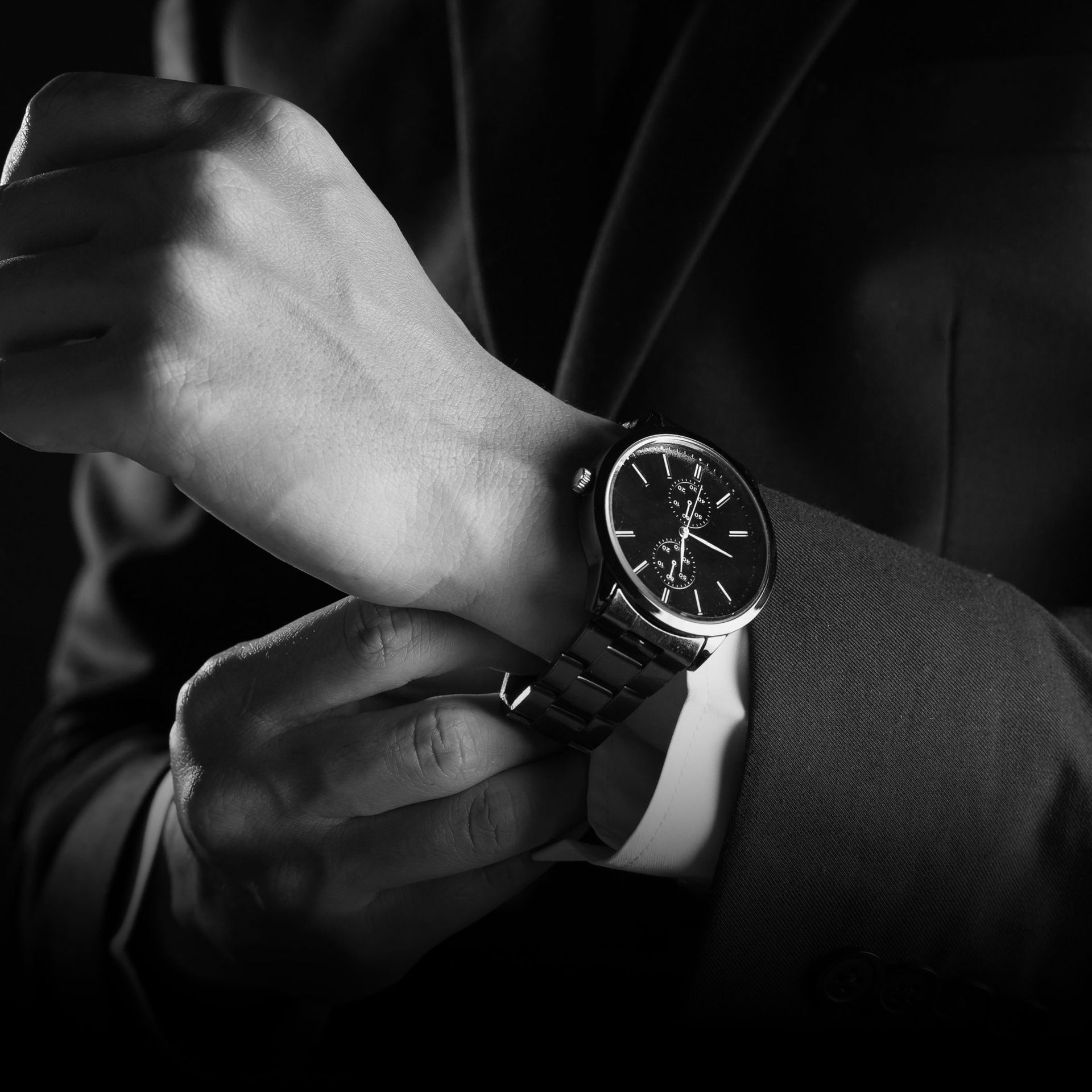 A black and white photo of a person wearing a watch