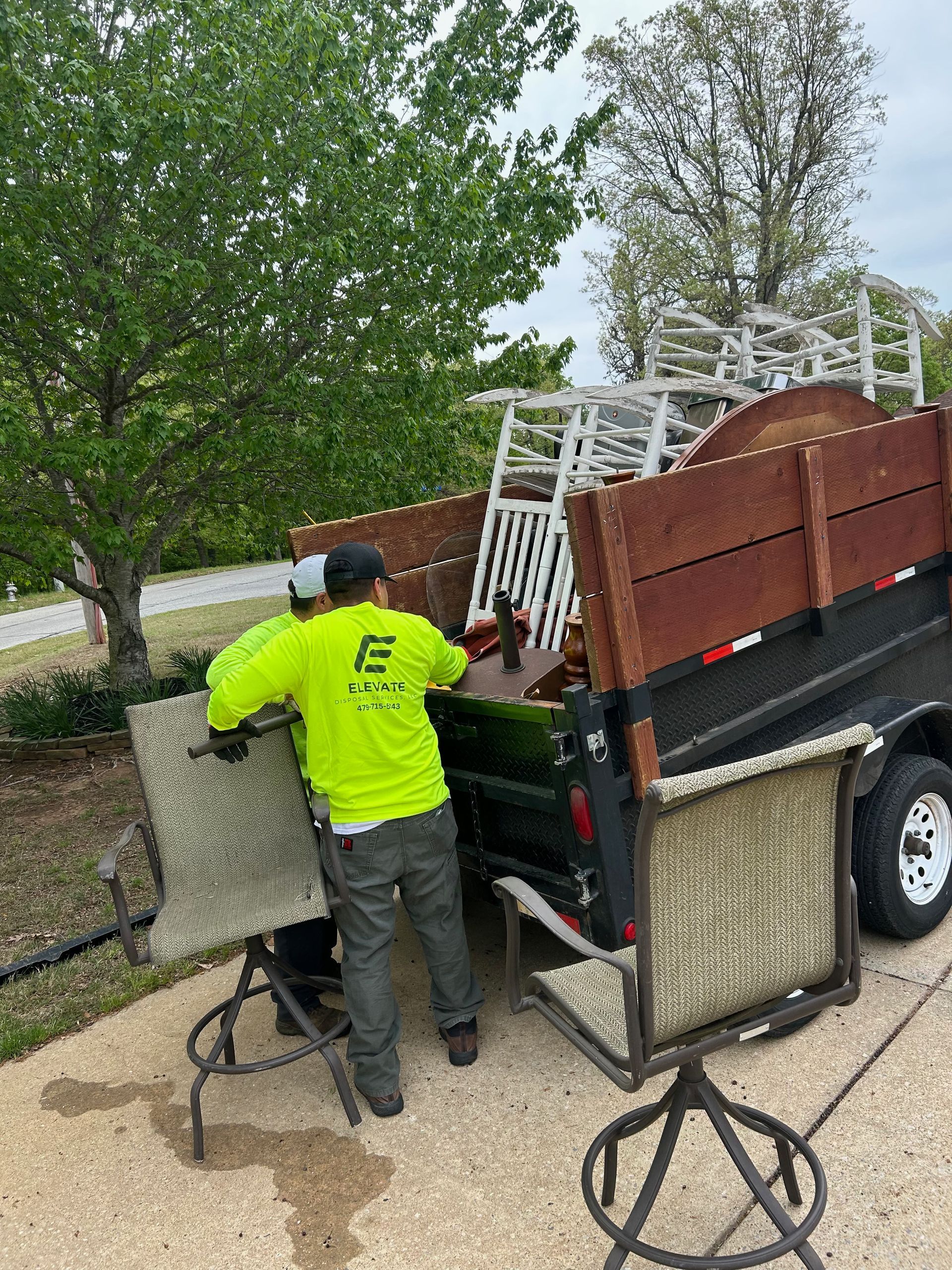 Elevate Disposal Services trash truck and a recycling bin