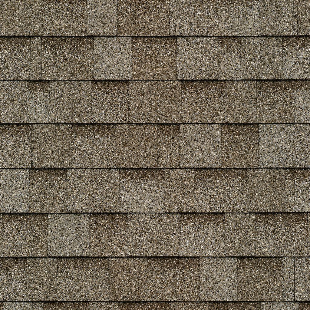 A close up of a row of brown shingles on a roof.