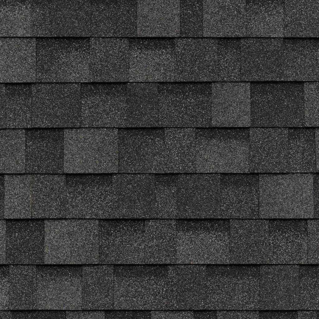 A close up of a row of gray shingles on a roof.