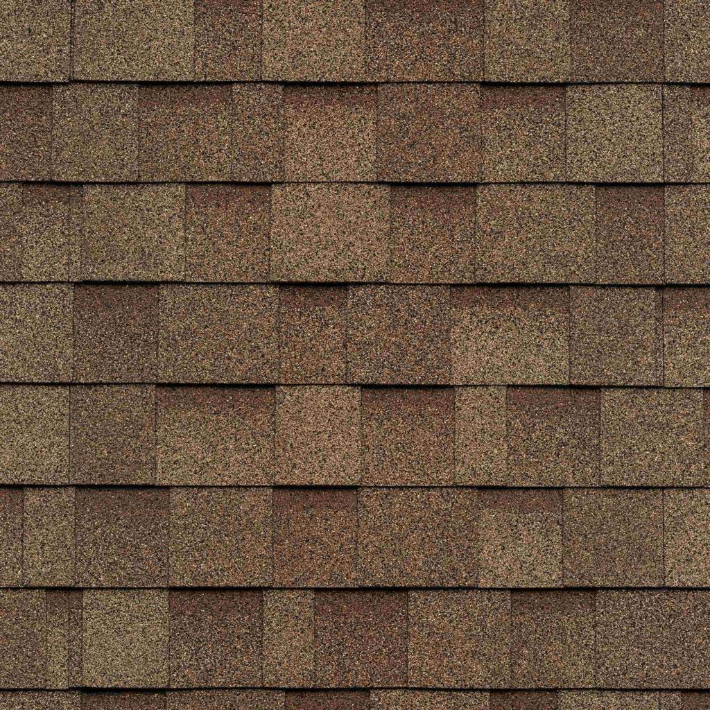 A close up of a roof with brown shingles.