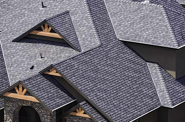 An aerial view of a house with a gray roof.