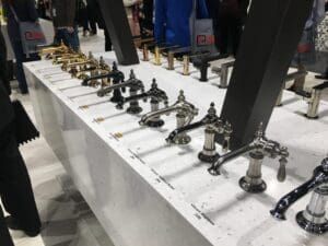 There are many different types of faucets on display on a table.