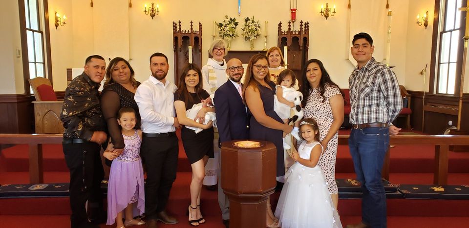 A large group of people are posing for a picture in a church.