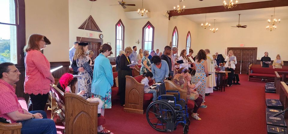 A large group of people are gathered in a church.
