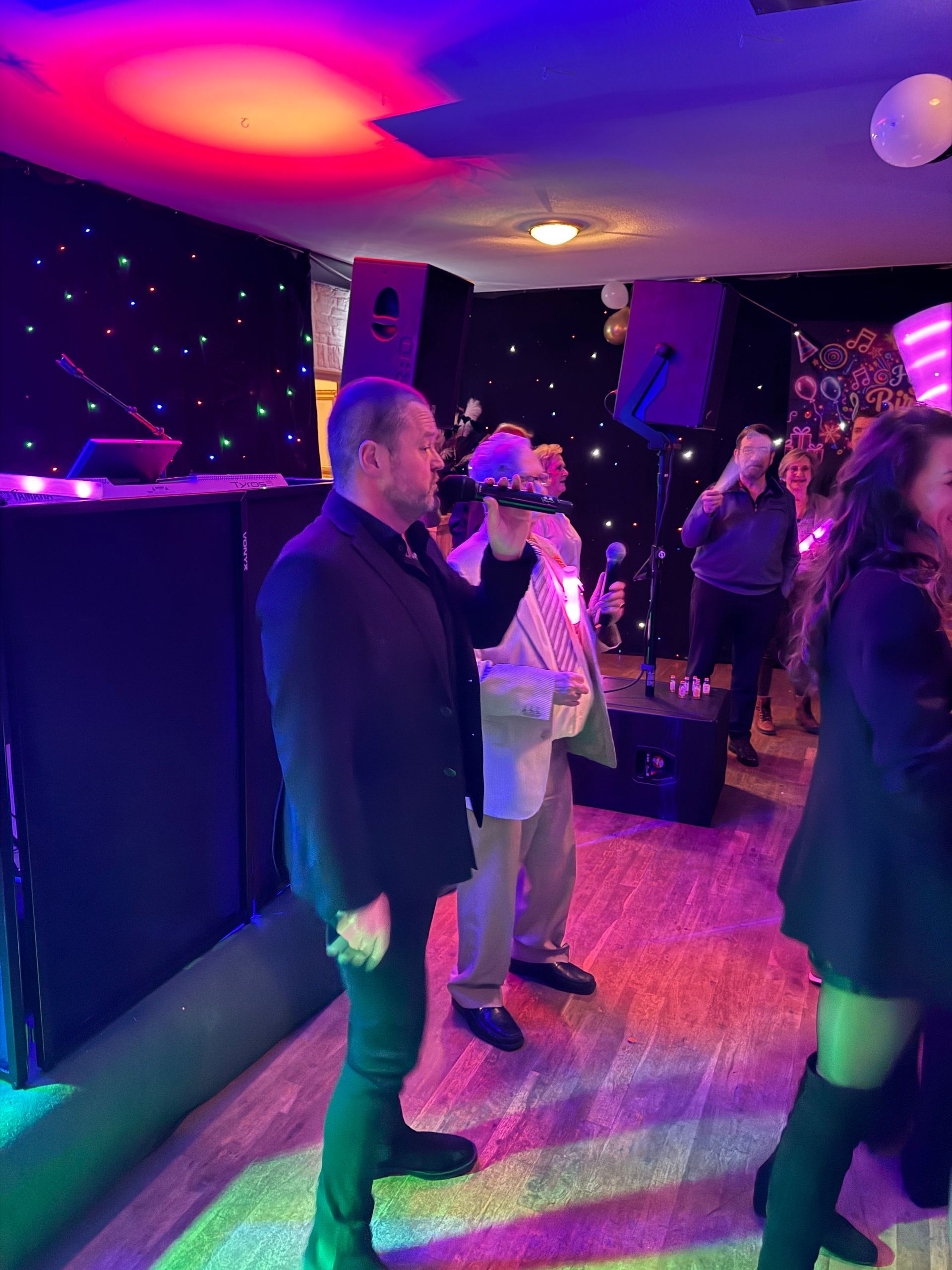 Een groep mensen staat in een kamer met een microfoon.