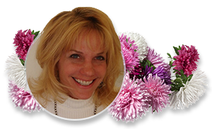 Smiling blonde woman framed by white and pink flowers on a white background