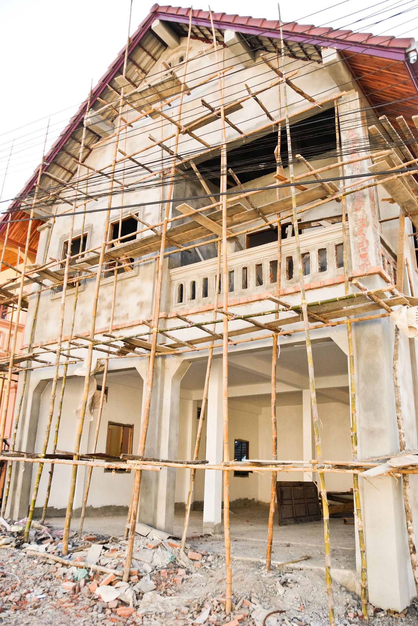 House under construction with scaffolding, showcasing the process of building custom-built homes. House under construction with scaffolding, showcasing the process of building custom-built homes.