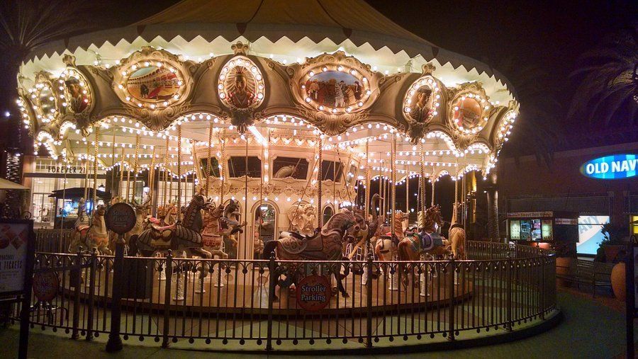 Illuminated carousel at night outside a shopping center in Irvine.