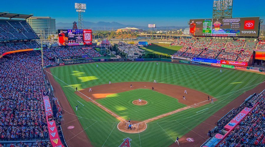 A baseball stadium filled with people watching a baseball game.