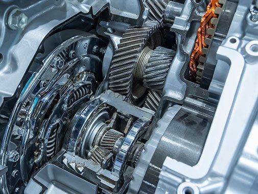 Vue en coupe d'une transmission automobile montrant les engrenages, les arbres et autres composants mécaniques dans un carter métallique.