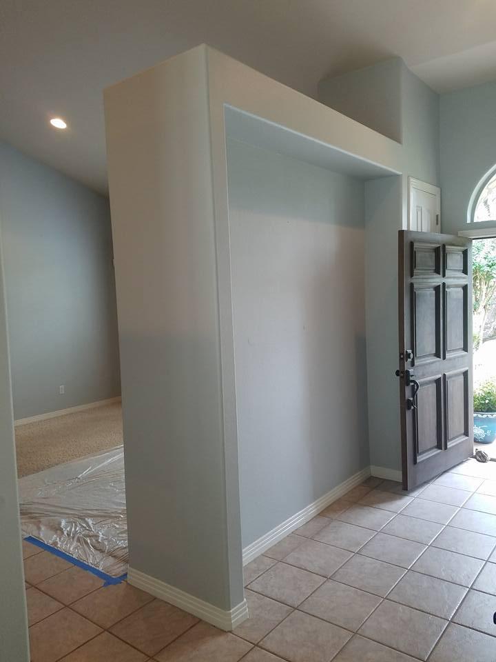 An empty room with a door and a wall.