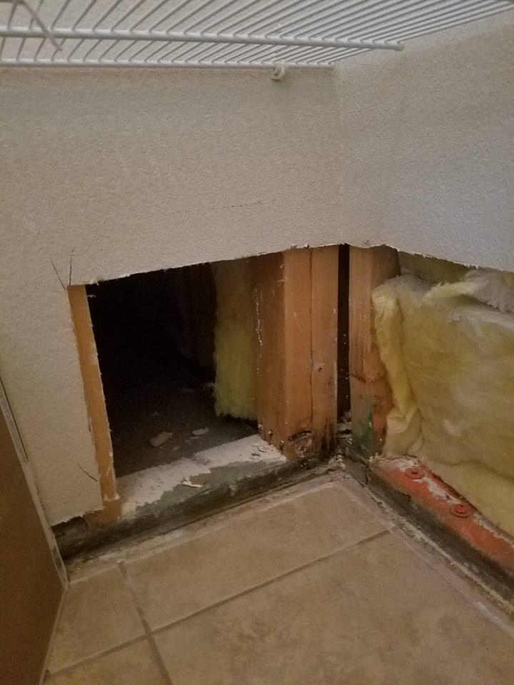 There is a hole in the wall in the corner of the room.