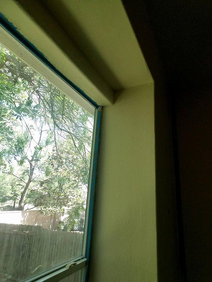 A window in a room with a fence in the background