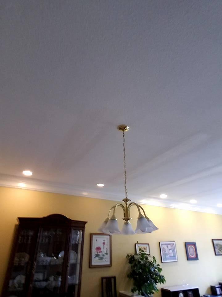 A living room with a chandelier hanging from the ceiling