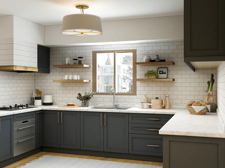 A kitchen with gray cabinets , white counter tops , a sink and a window.