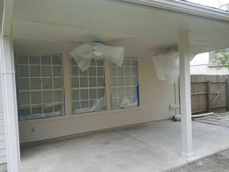 A white house with a covered porch and windows.
