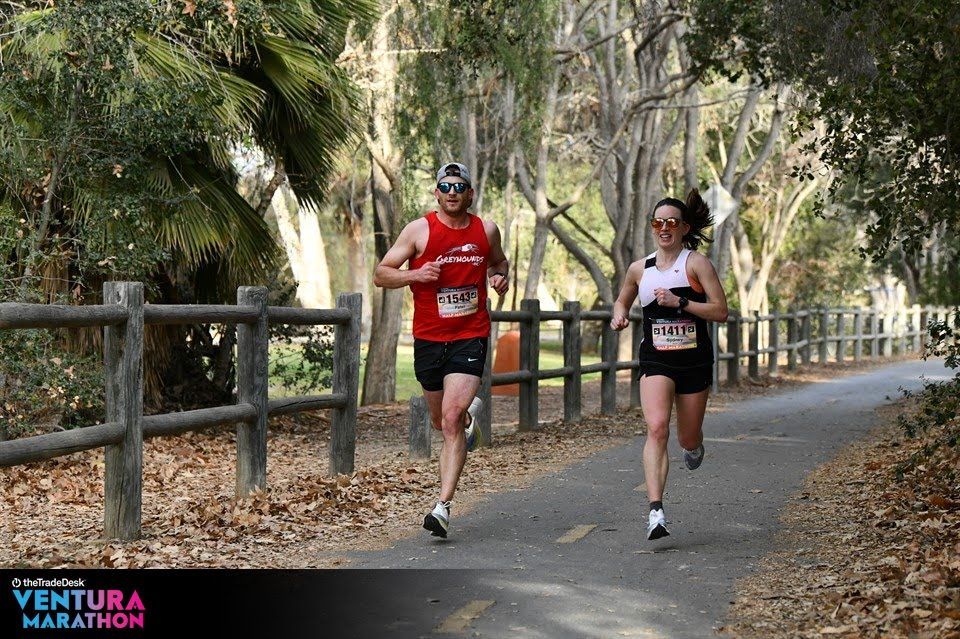 Ventura Marathon - Male and female participants running down the bike path. Half Marathon Info page.