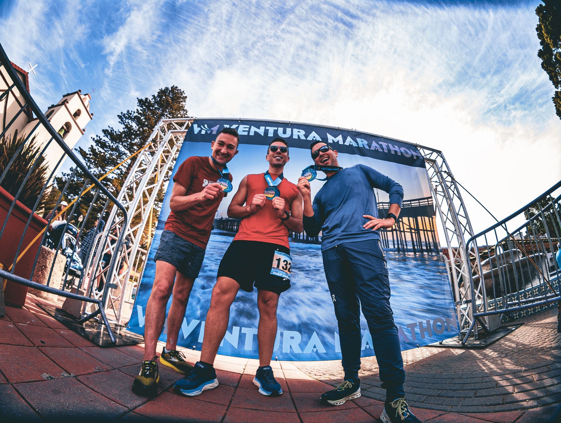 3 Runners showing off their Ventura Marathon Finishers Medals