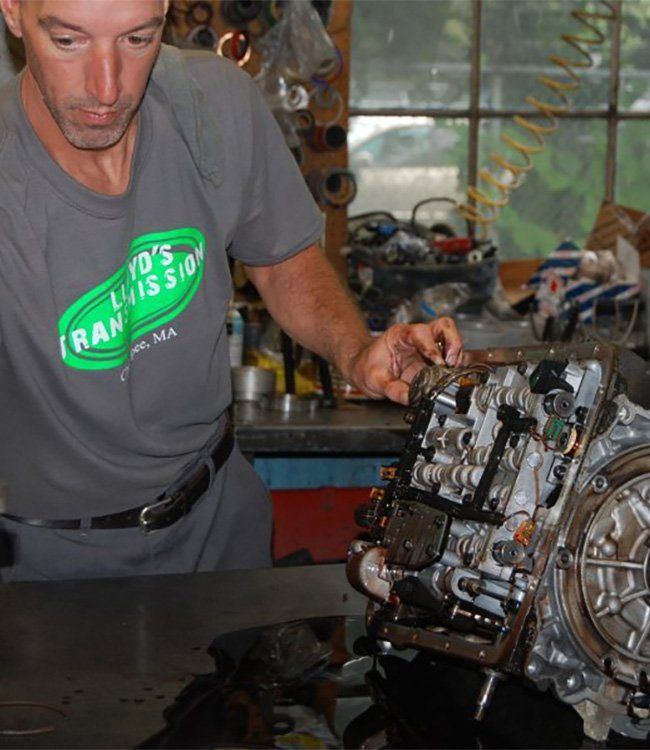 Man Replacing the Pan Gasket — Chicopee, MA — Lloyd's Transmission Inc.