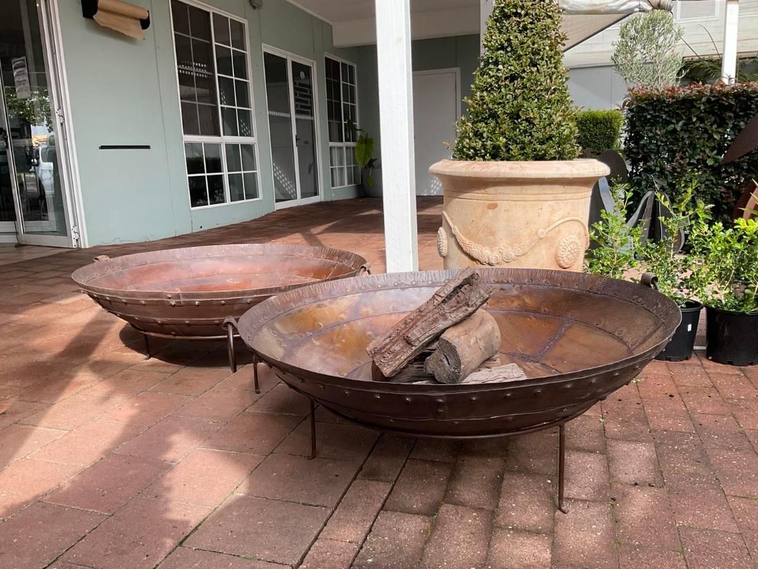 Three Fire Pits Are Sitting On A Brick Patio In Front Of A Building — Magnolia Nursery In Dubbo, NSW