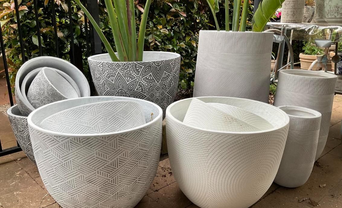 A Group Of White Pots Sitting On Top Of A Table — Magnolia Nursery In Dubbo, NSW
