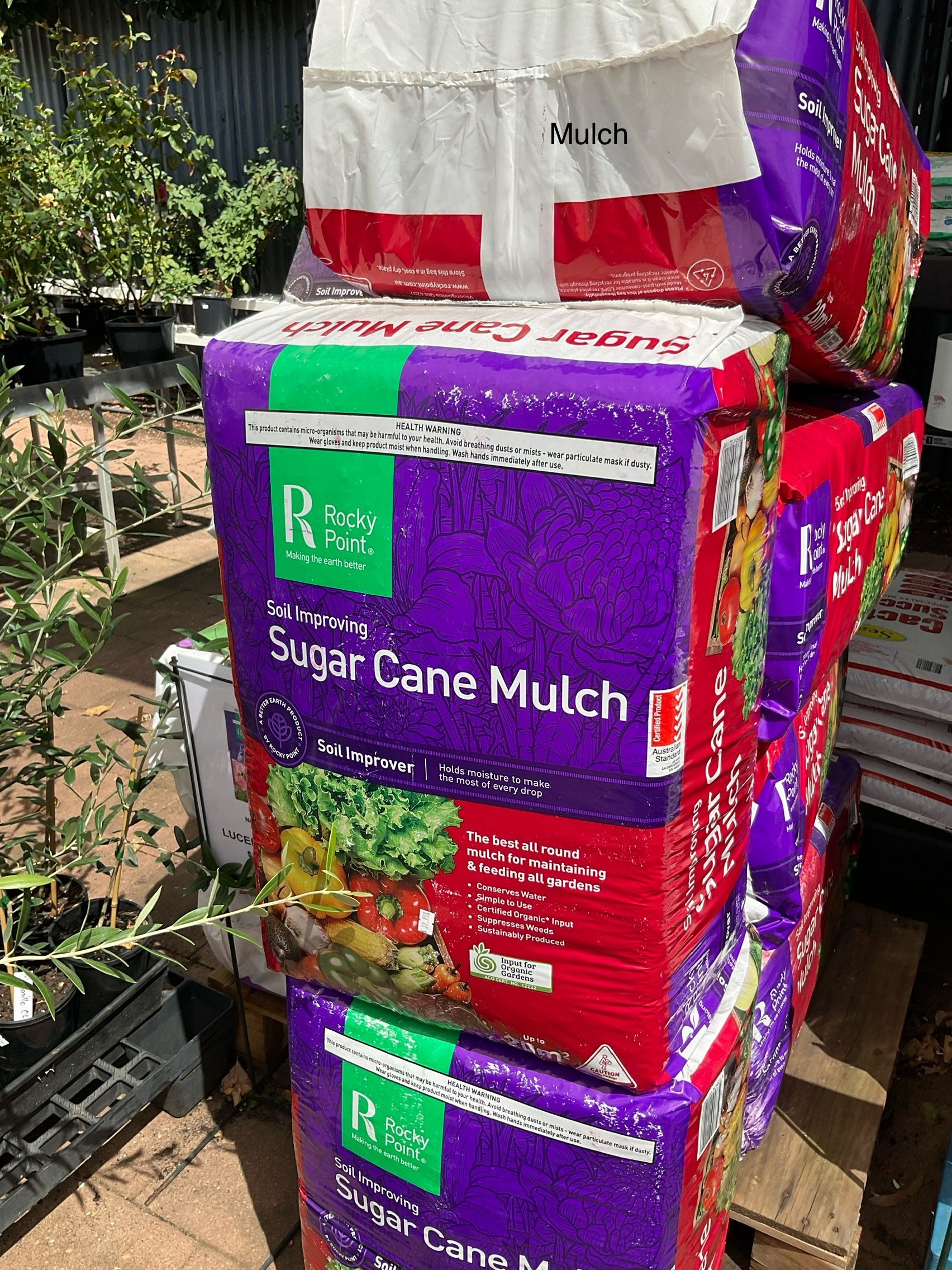 Several Bags Of Mulching Pellets Are Stacked On Top Of Each Other — Magnolia Nursery In Dubbo, NSW