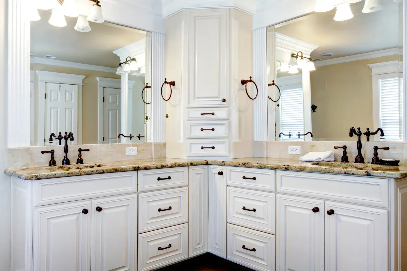 A bathroom with two sinks and two mirrors