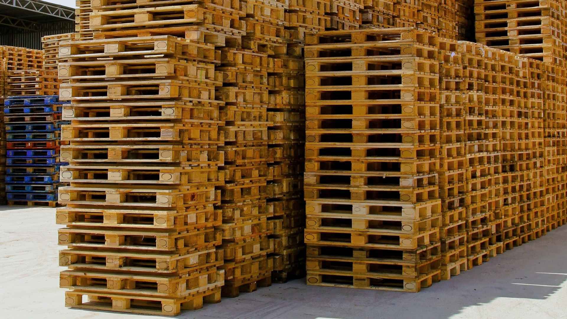 A bunch of wooden pallets are stacked on top of each other