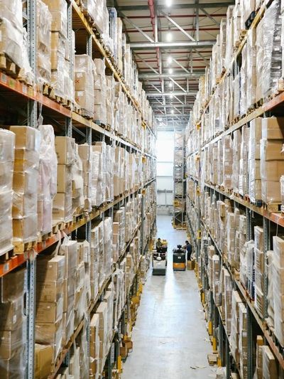 A large warehouse filled with lots of boxes and shelves.