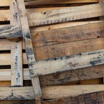 A bunch of wooden pallets are stacked on top of each other.