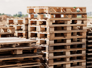 A pile of wooden pallets stacked on top of each other.