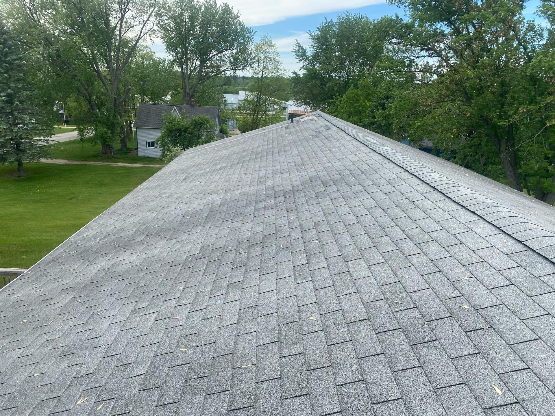 Interior view of a room under construction with white drywall ceiling and walls, recessed lighting fixtures.