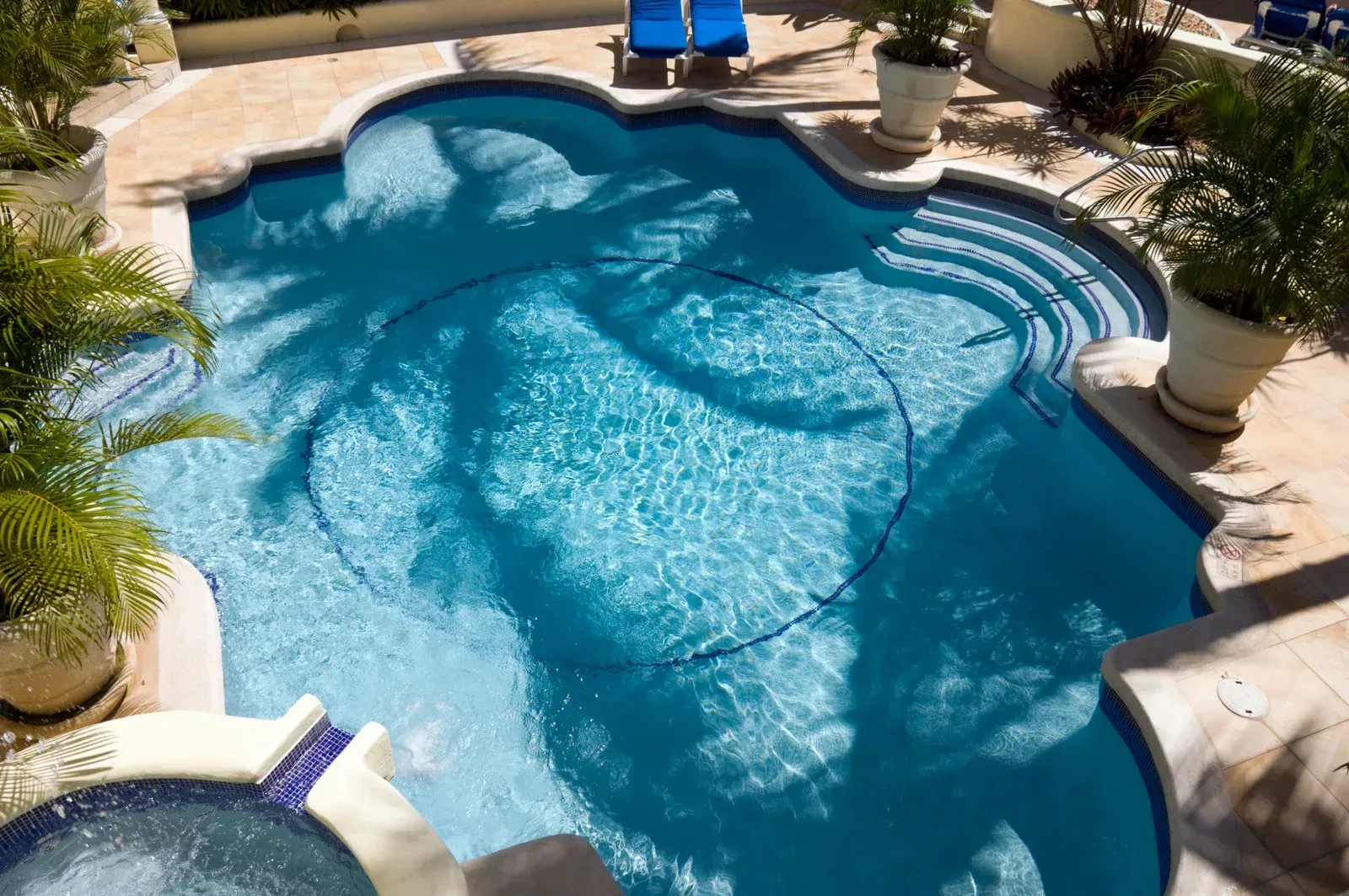 Two-story house with green siding, white trim, and a wrap-around porch; landscaped front yard.
