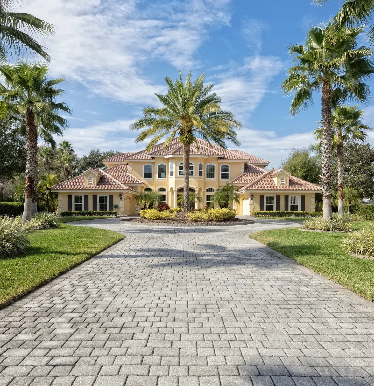 Wooden gazebo in a grassy area, surrounded by trees.