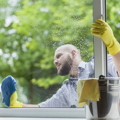 man with beard Cleaning a window