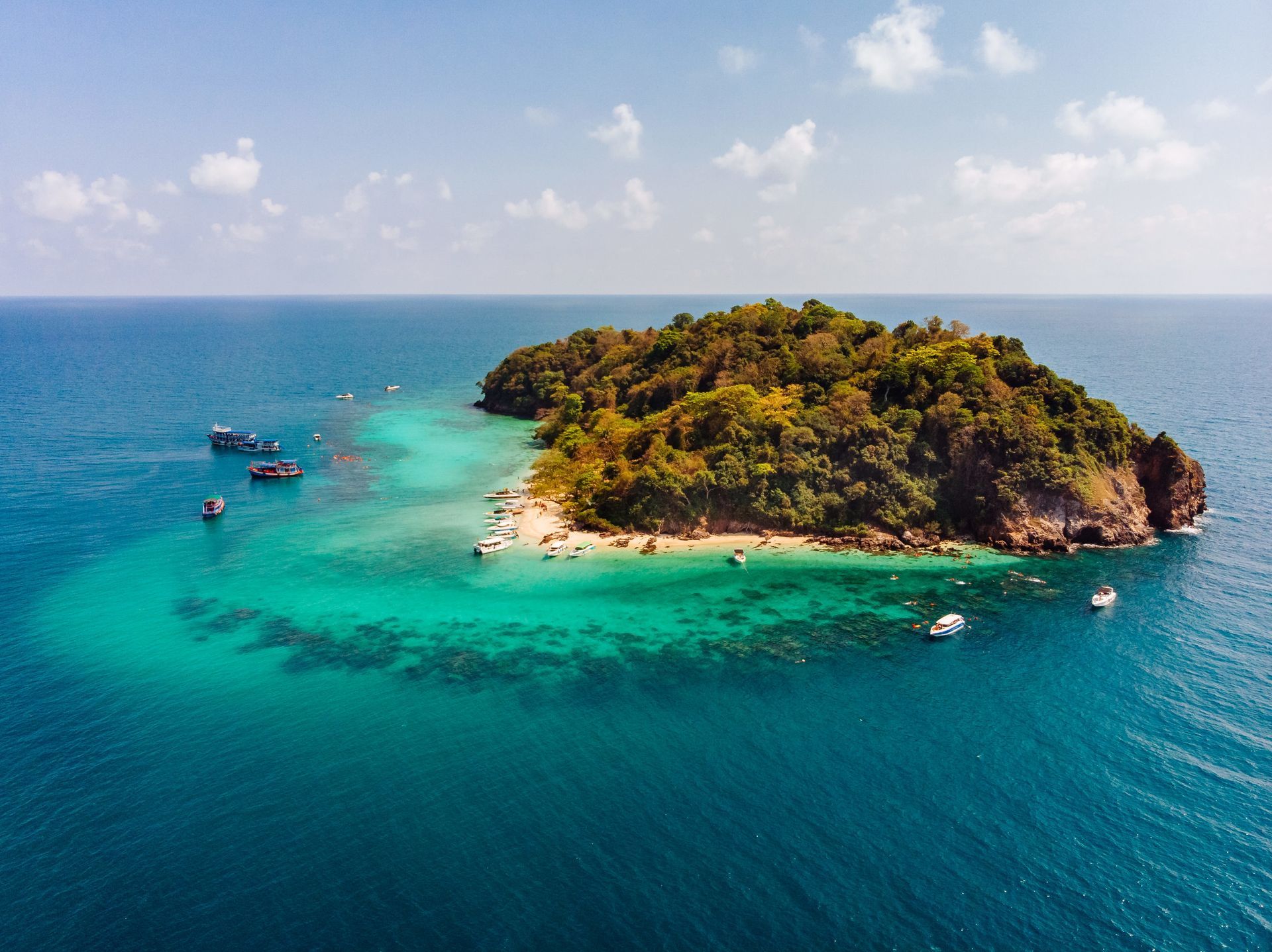 An aerial view of a small island in the middle of the ocean.