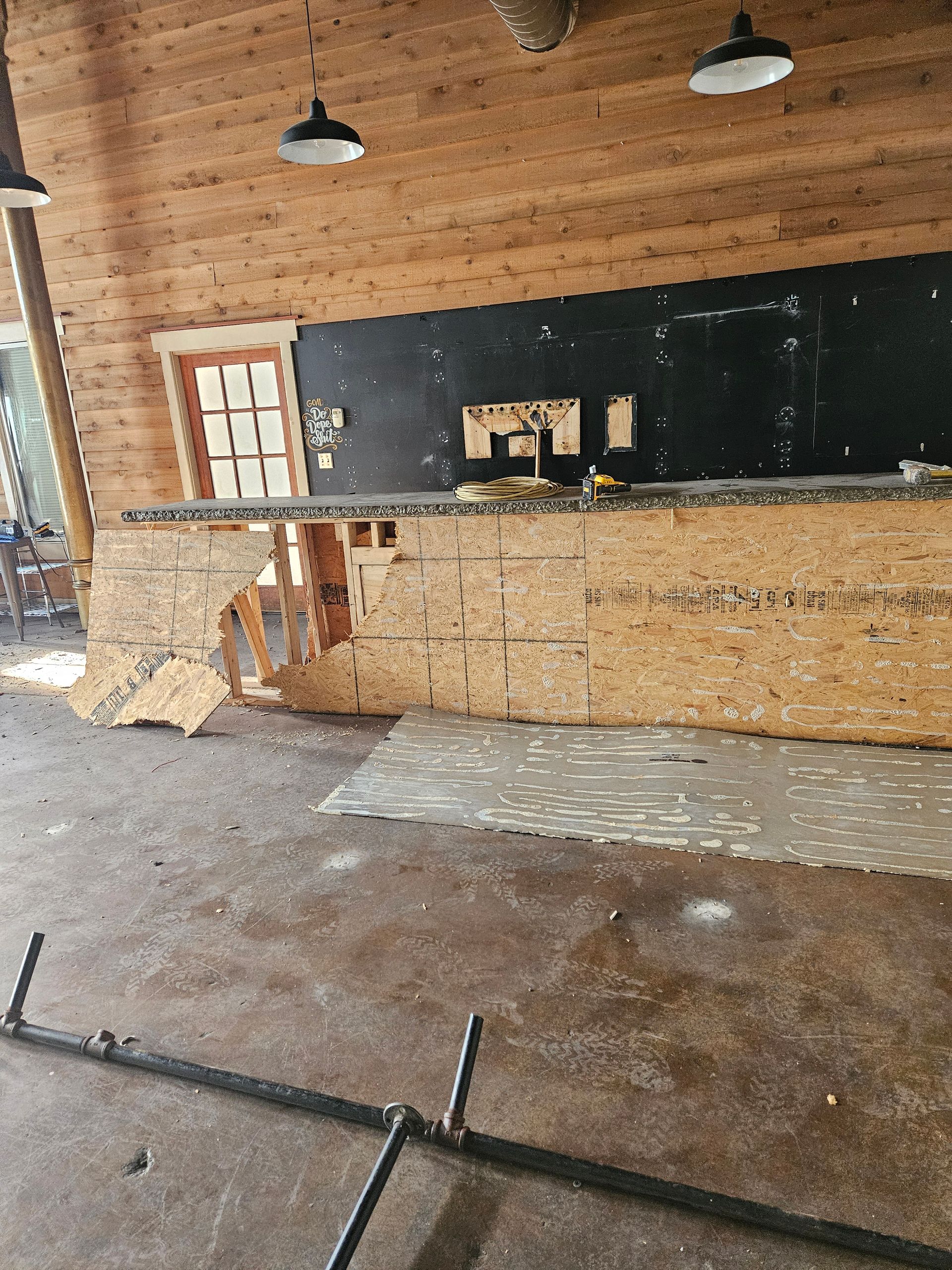 A blue trash can filled with old batteries on a table.