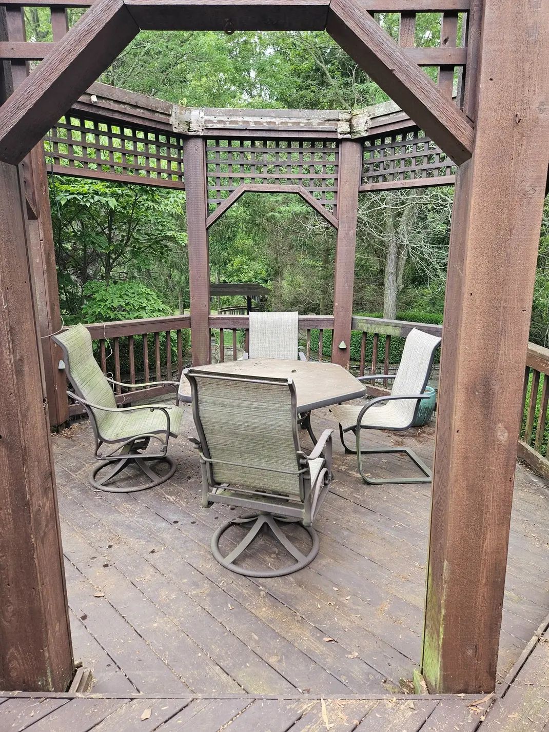 A gazebo with a table and chairs on it