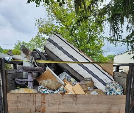 A stack of metal boxes sitting on top of each other in a field.