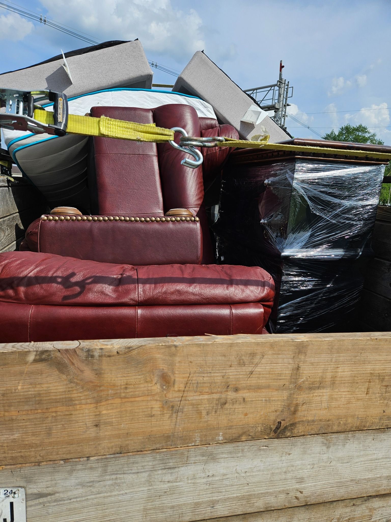 A hot tub is sitting on a wooden deck in front of a house.
