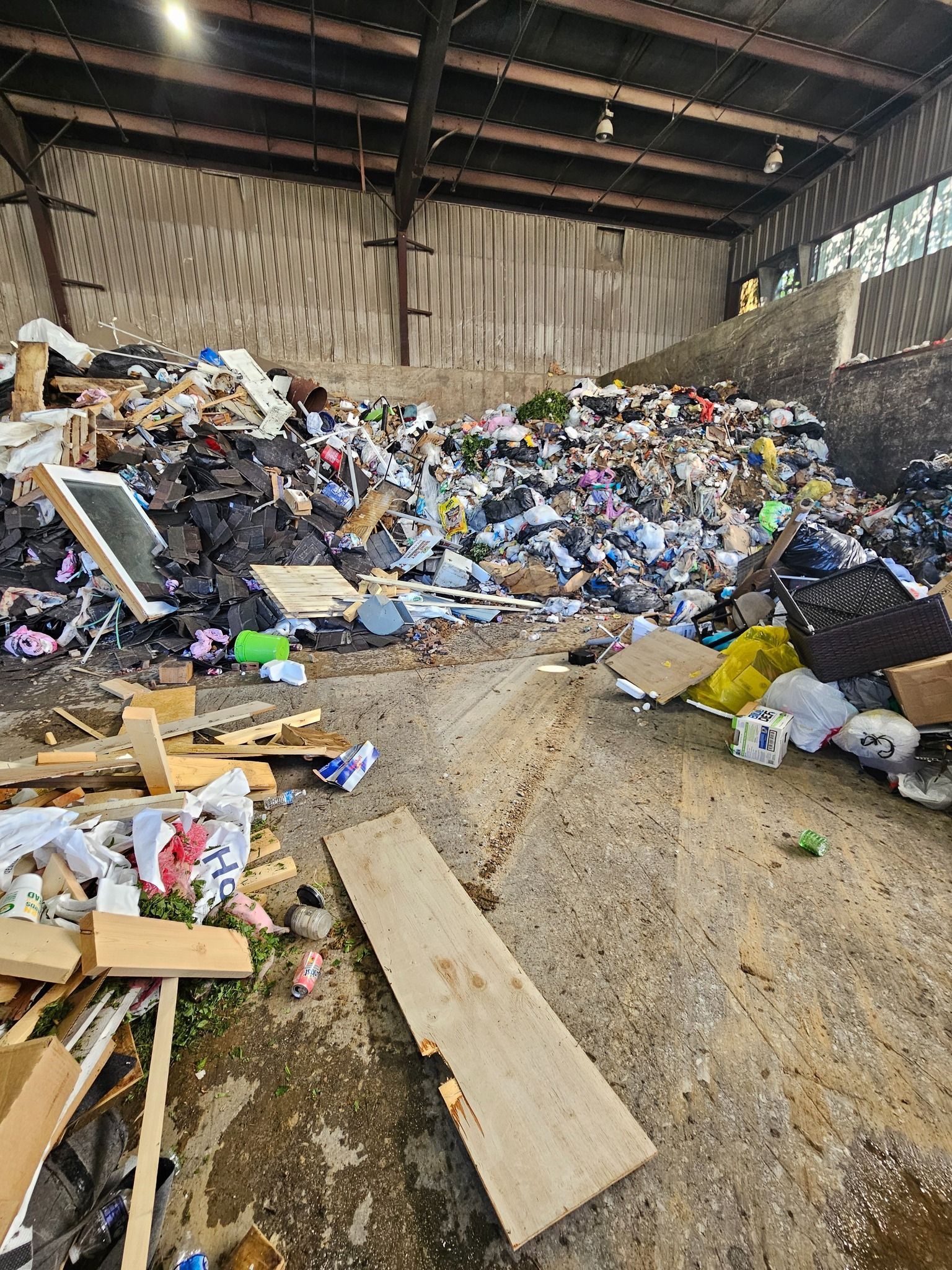 Three buckets of paint are stacked on top of each other.