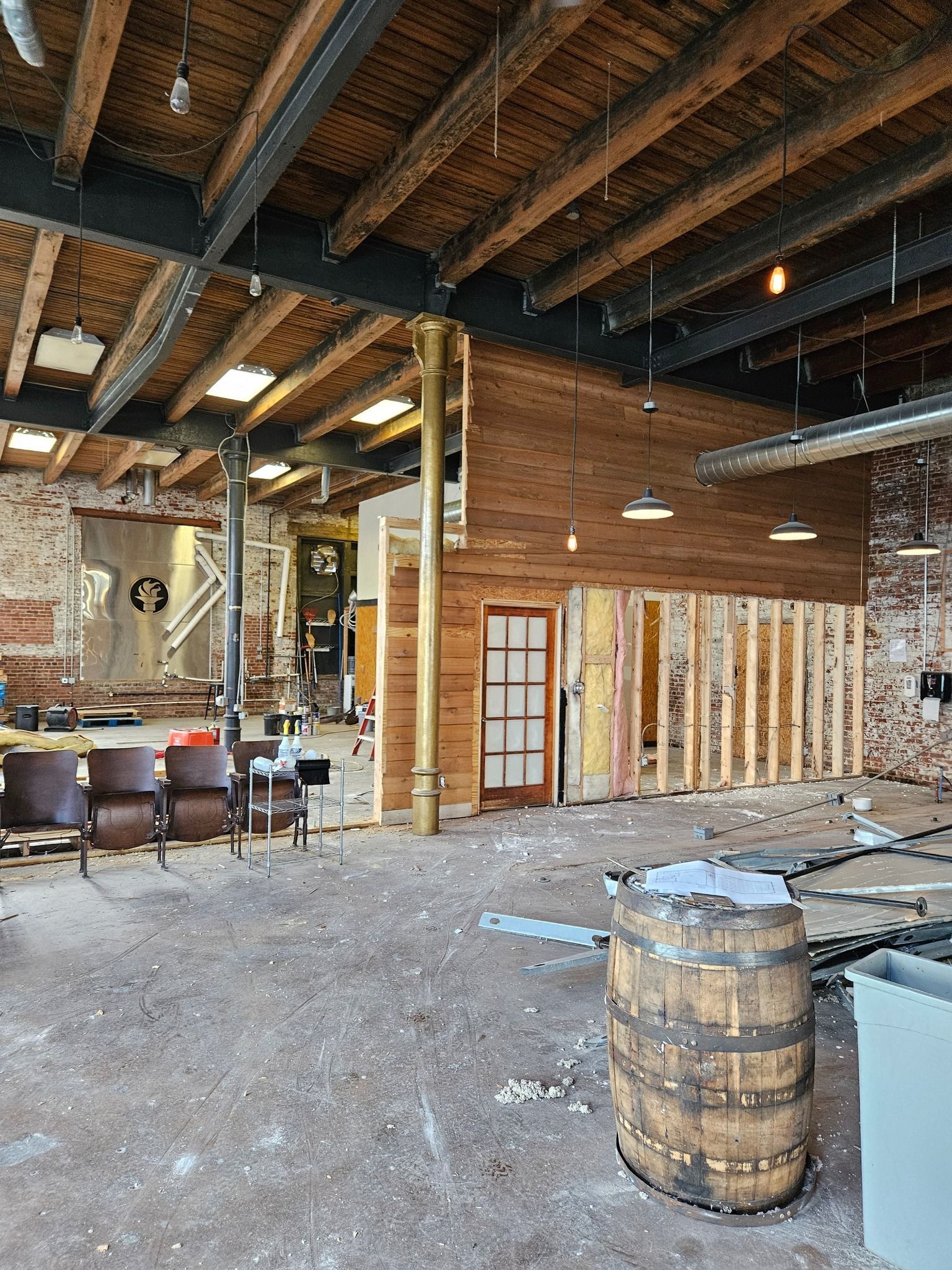 A blue trash can filled with old batteries on a table.