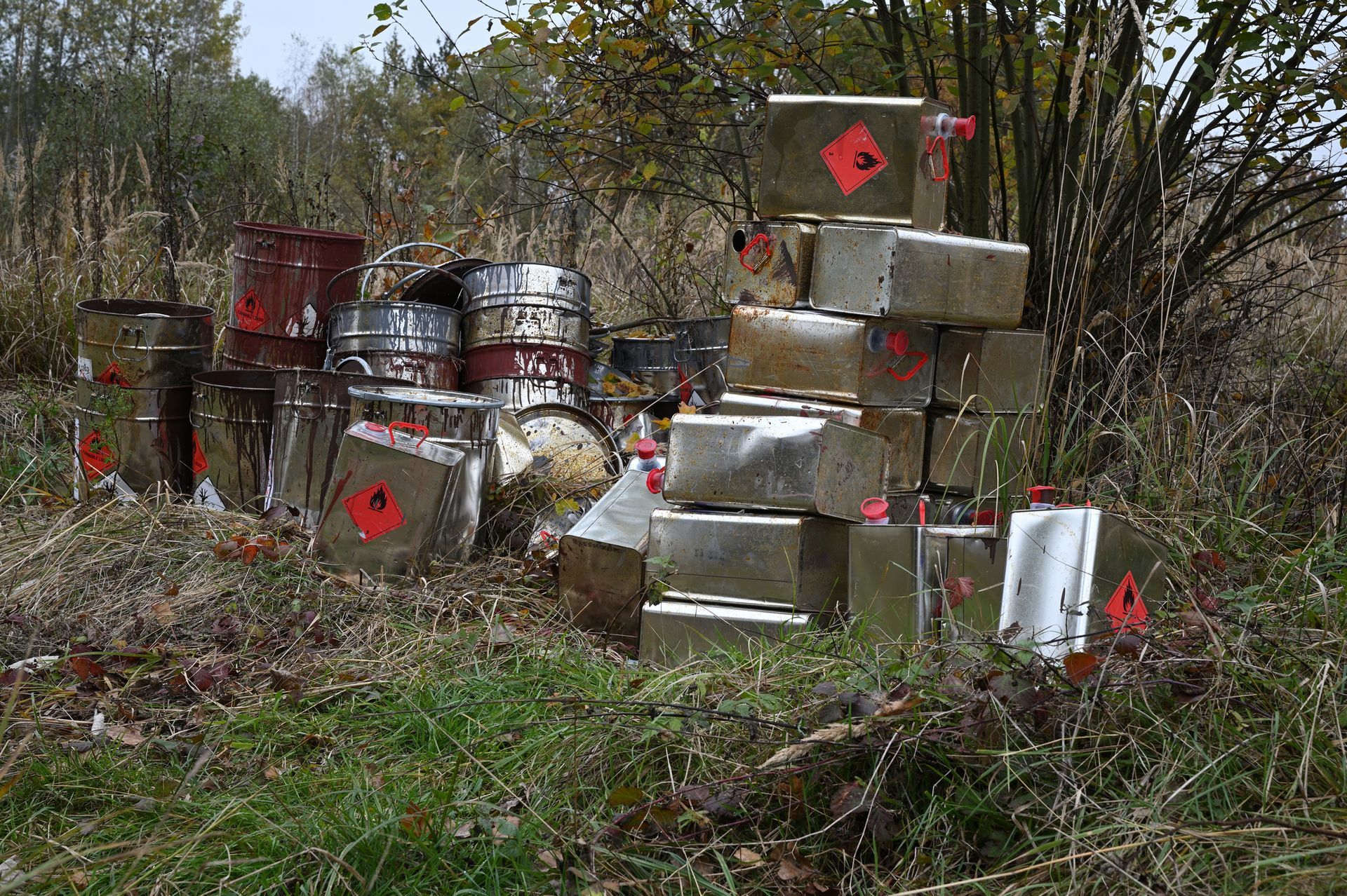 A stack of metal boxes sitting on top of each other in a field.