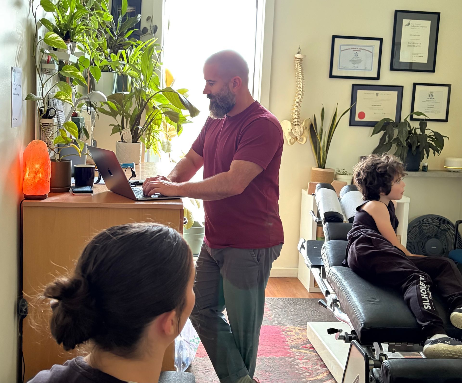 A family is posing for a picture in a park.