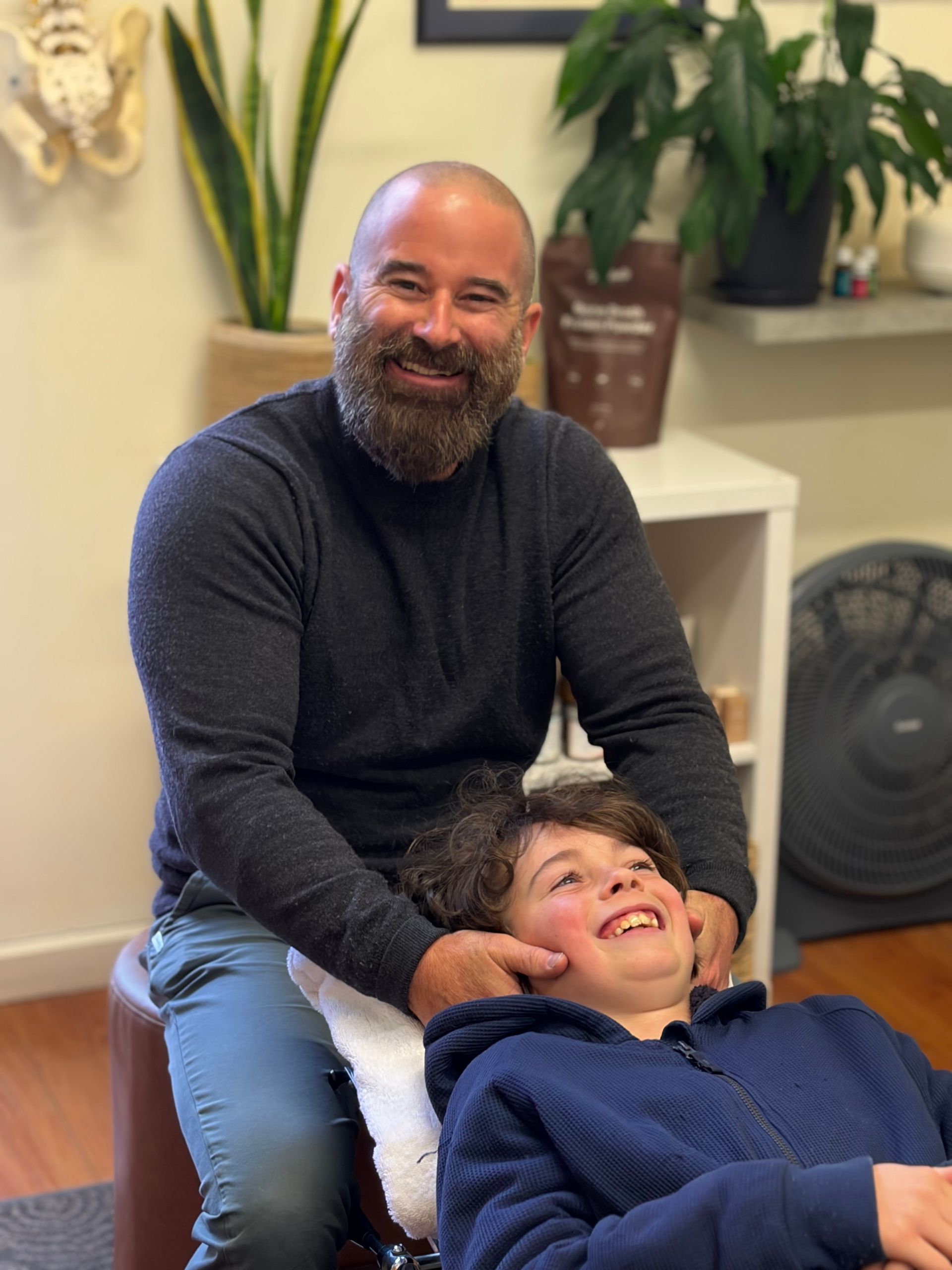 Dr John Sutherland adjusting his son in clinic