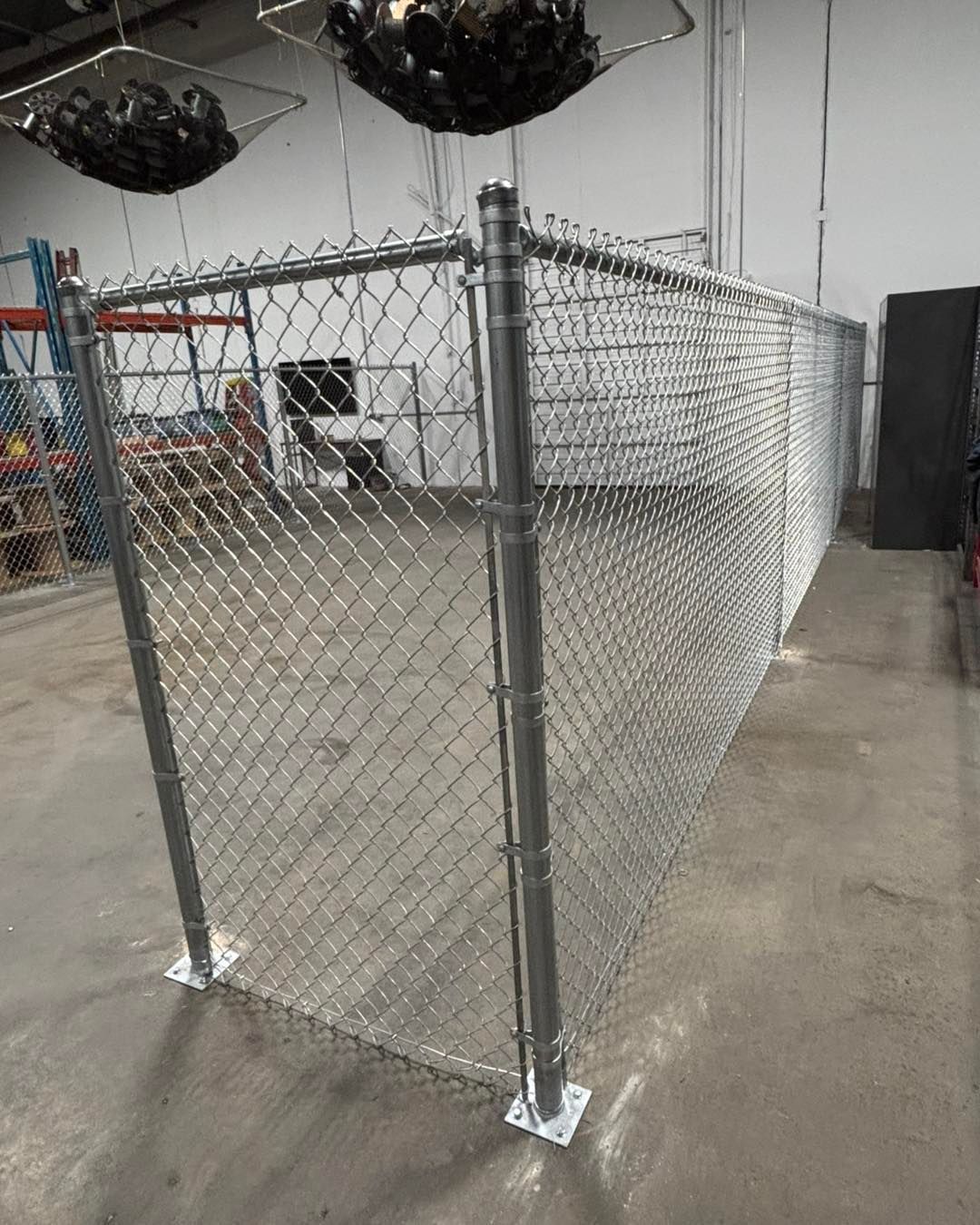 Chain link fence enclosure in an industrial setting.